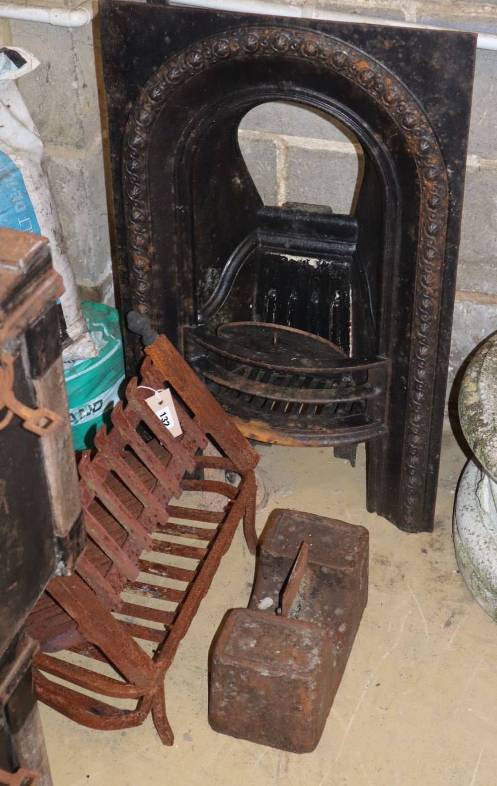A fire place, two fire grates and a boot scraper, largest grate W.46cm, D.76cm.
